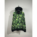 Green Supreme skull patterned hoodie on a hanger against a neutral background
