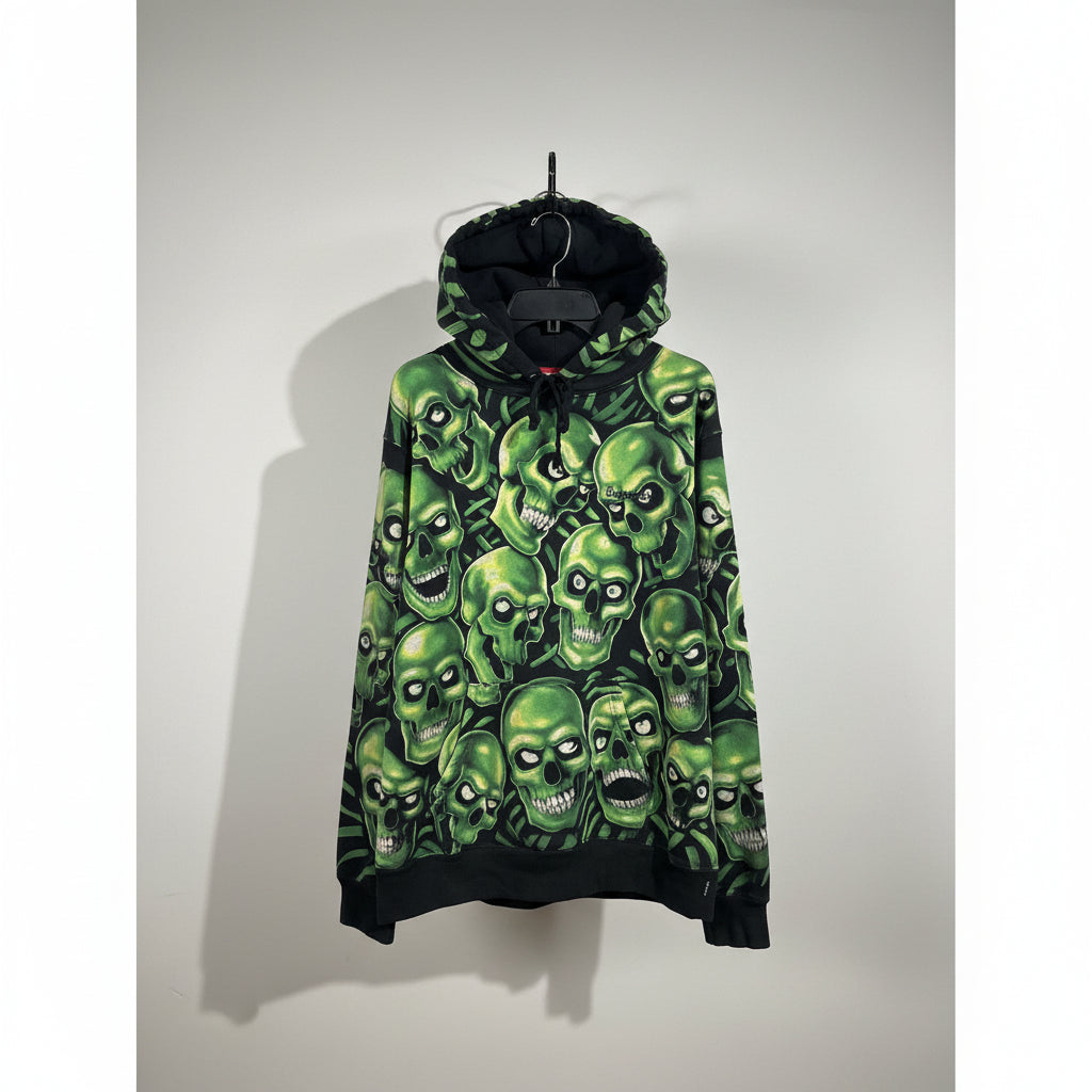 Green Supreme skull patterned hoodie on a hanger against a neutral background