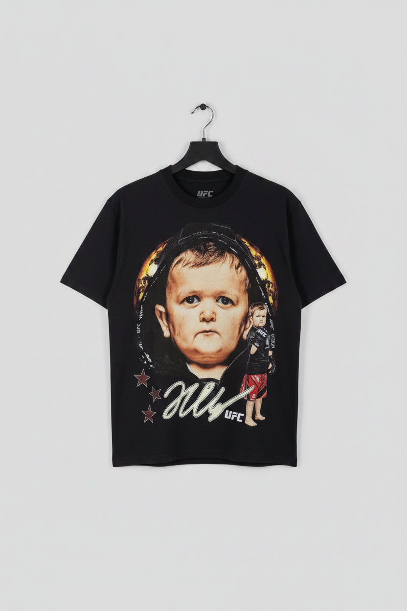 Black t-shirt with a graphic of a baby and text, displayed on a hanger.