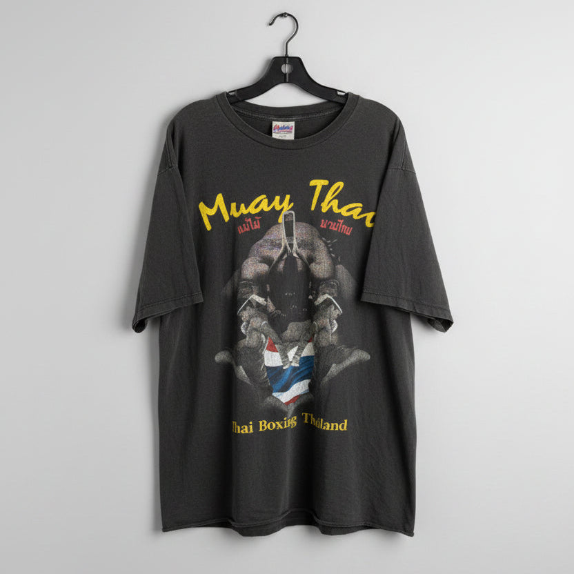 Gray t-shirt with graphic design and text on a wooden background