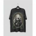 Gray t-shirt with skull design hanging on a wooden panel wall